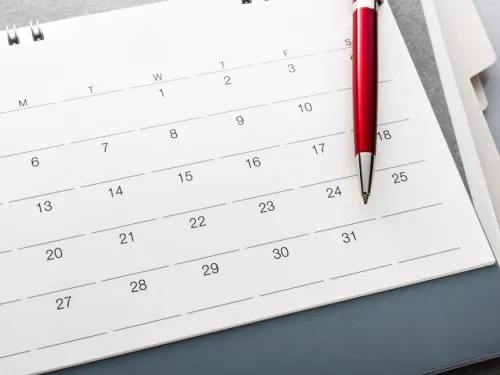 calendar page with pen resting on the page