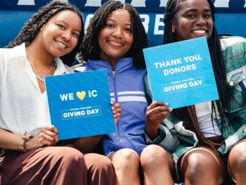 Students in the big chair, celebrating Giving Day. Photo Credit: Allison Usavage '11.