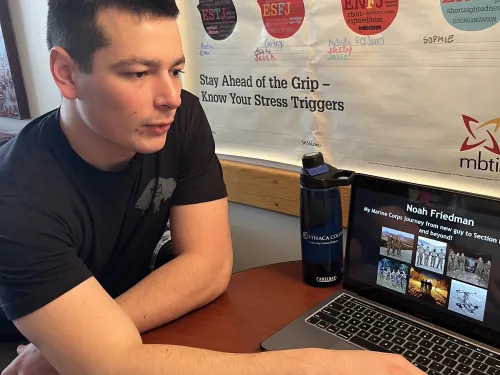 Student showing leadership work on laptop