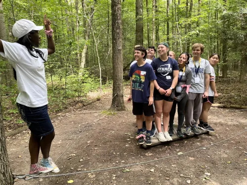Students balancing on a board 
