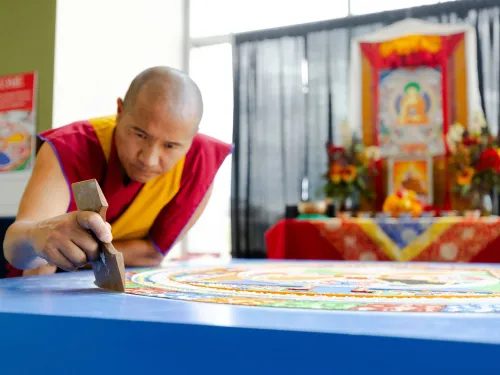 Buddhist monk creating a sand mandala.