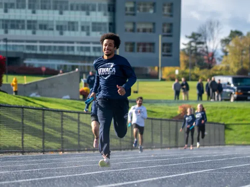 A college student runs on a track.