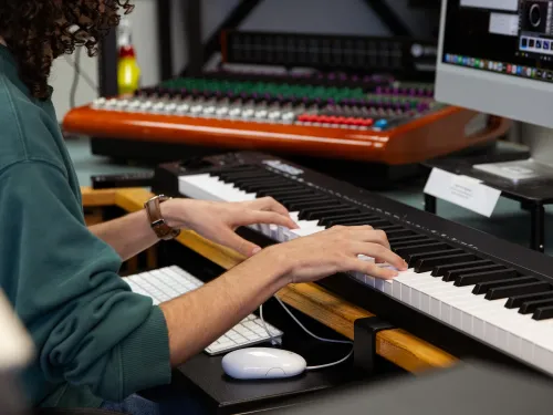 student in the electroacoustic music studio