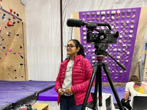 Student on set in a rock climbing gym