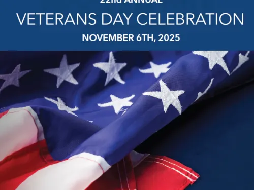 Poster promoting the Veterans Day Celebration with a US flag on it.