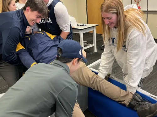 Students practicing cold water immersion scenario