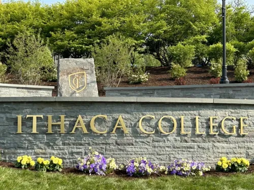 Decorative stone wall with the words Ithaca College on it.