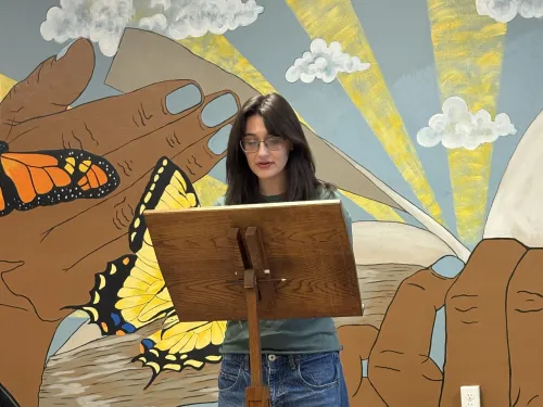 Jade Ferrante reads an author introduction at the New Voices Festival