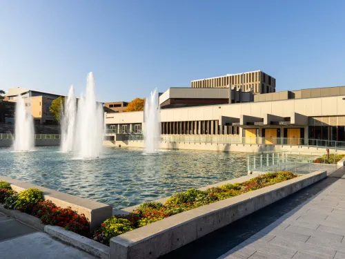 A building on a college campus with fountains.