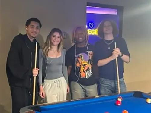 Image of Students holding pool cues in the Rec Center.
