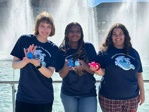 Image of Health Promotion Ambassadors holding Walter Whaleness Whale in front of Dillingham Fountains