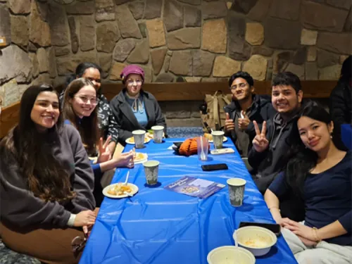 Image of students seated around table at Interfaith Dinner series.