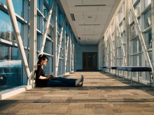 Student sitting in Hallway.
