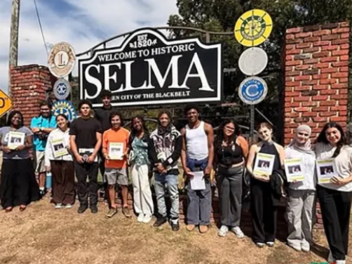 Image of MLK Scholars posed in front of town sign in Selma.
