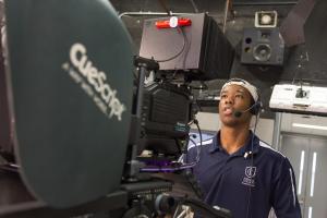 Student operates a television camera. 