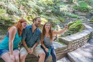 Students take a selfie in Buttermilk Falls State Park