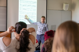 Professor Posegate teaching  music history class
