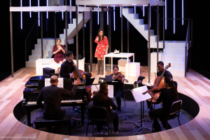 Ithaca College students perform an opera on stage with musicians in the pit