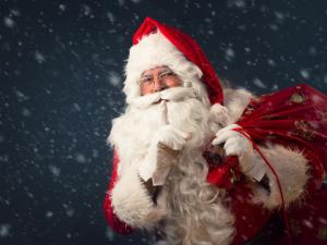 Santa making the shushing gesture