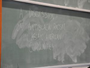 Text on a black board reading "A discussion on anti-black racism in asian american communities"