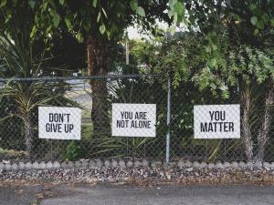 don't give up. You are not alone, you matter signage on metal fence. Photo by Dan Meyers on Unsplash