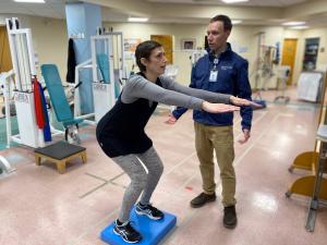 Physical therapist works with patient
