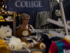 Woman browses college-branded merchandise.