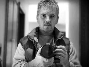 Photo of John Noltner holding camera. 