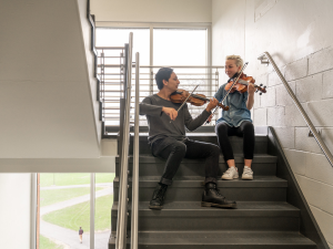 a pair of students practicing in the stairwell