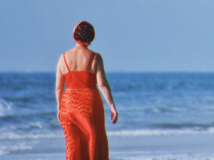 woman in red at beach