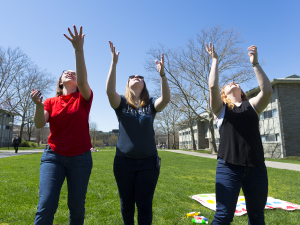 students tossing water balloons in the air