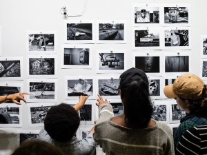 Students looking at photographs on the wall