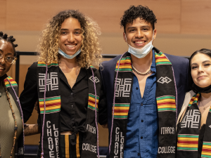four students with a black stole 