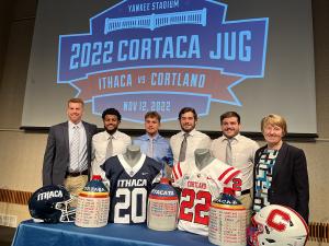 Coaches and players in front of the Cortaca Jug