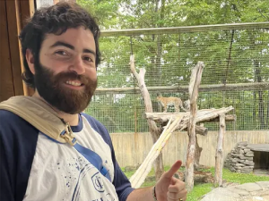 Photo of Dan standing by leopard enclosure
