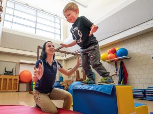 physical therapy student working with child
