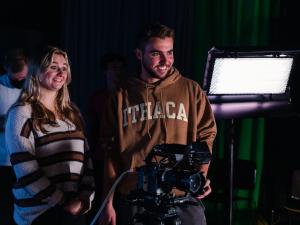 2 Students working with cameras and lighting