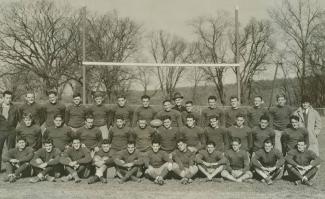 Black-and-white photo of players posing on field.