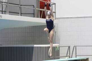 A woman jumping off a diving board