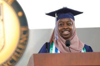 Fatoumata Jallow smiling at a podium