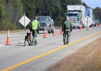 Law enforcement officers at a roadside checkpoint