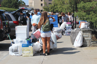 Students moving their things from their cars on Move-In Day