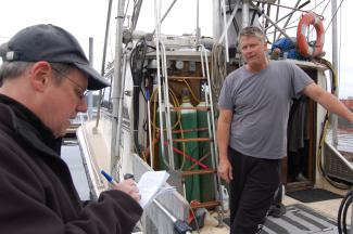 Todd McLeish interviewing an Alaskan fisherman