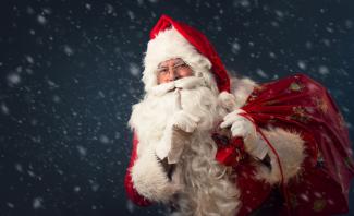 Santa Claus making the shushing gesture
