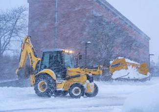 Front loader removing snow from parking lot