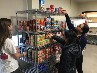 Students stock the shelves at the food pantry