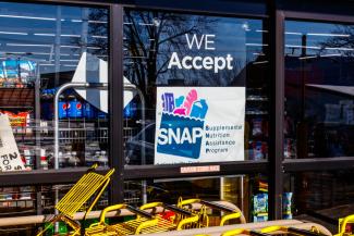 A storefront with a sign about SNAP
