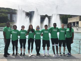 A group of young people in front of fountains