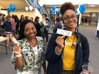 Students holding tickets