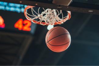 A basketball falling through a hoop